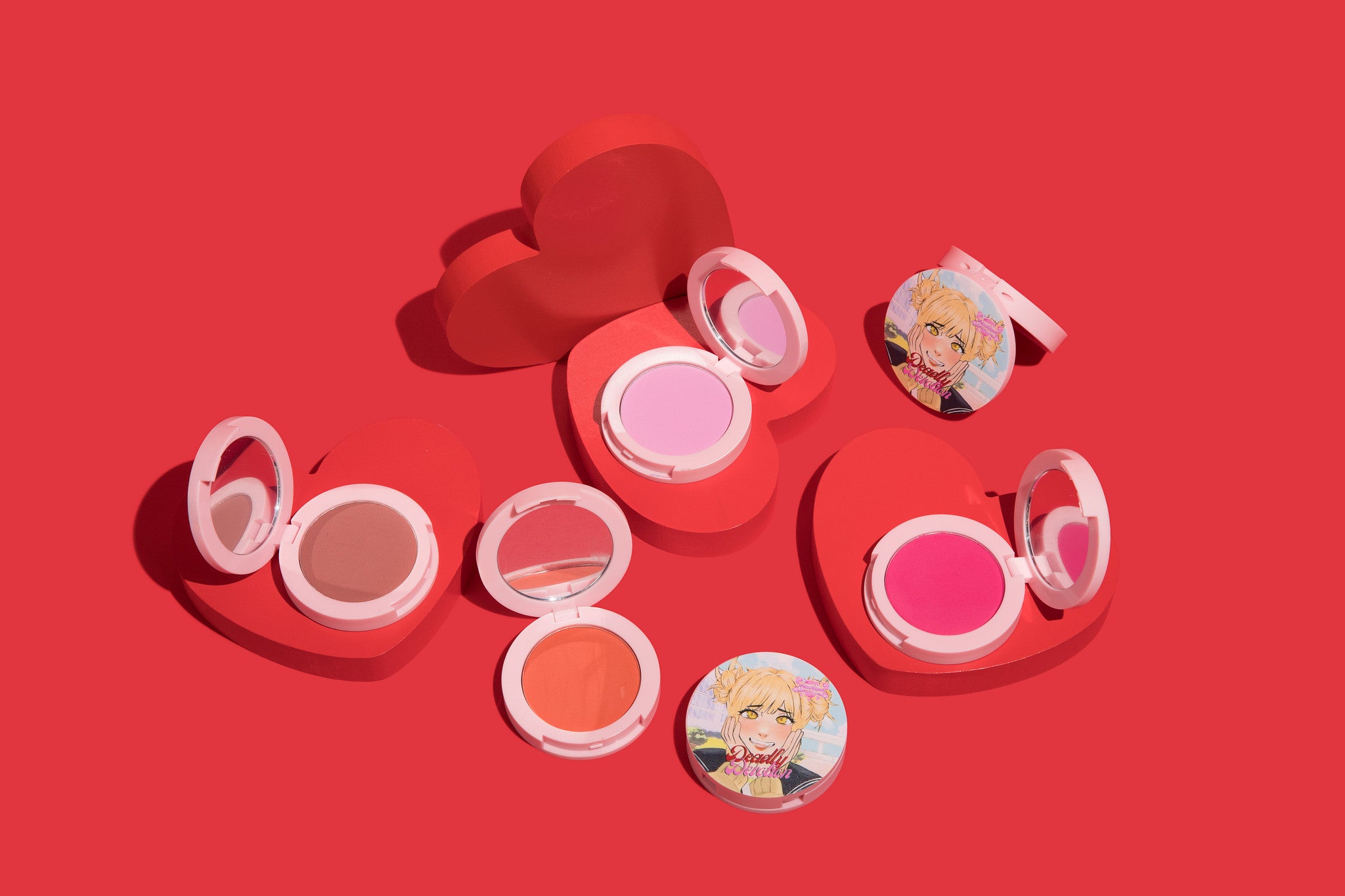 Makeup products with cartoon character stickers on a red background
